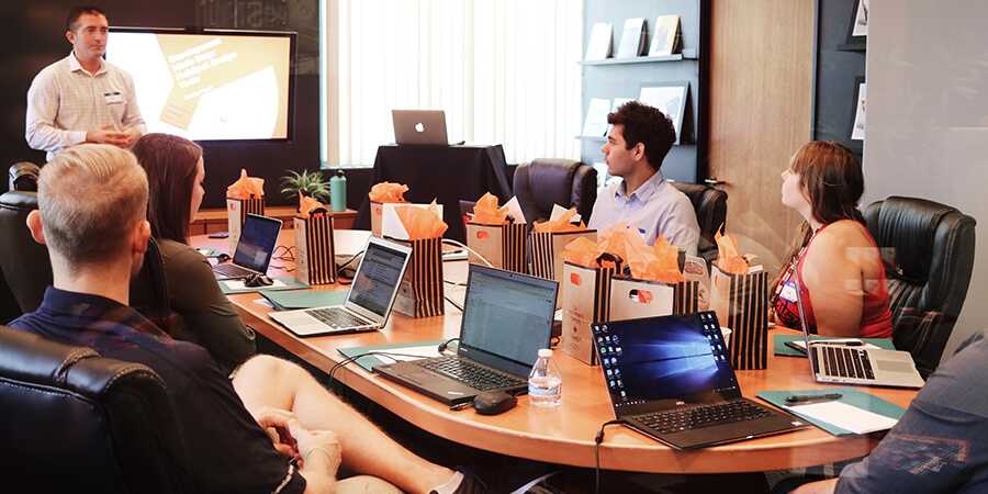 Leader chairing a meeting in a modern office.
