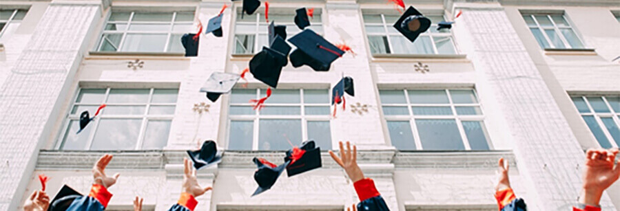 Graduates throwing their hats.